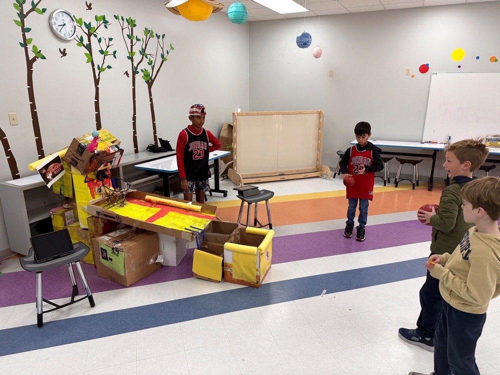 Students at cardboard arcade